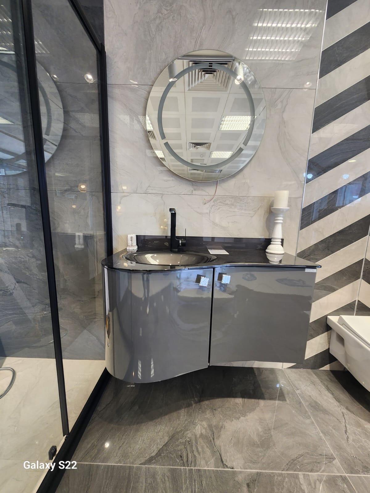 Gri parlak banyo dolabı ve yuvarlak ayna